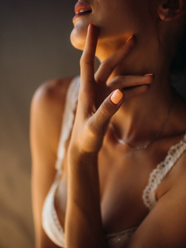 Woman in white lingerie touches her neck tender