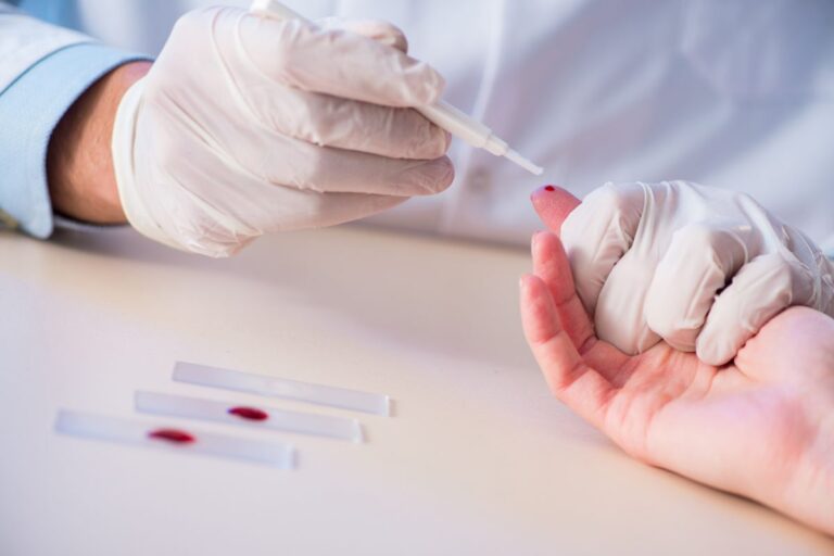 pessoa com luvas fazendo um teste de sangue em outra pessoa