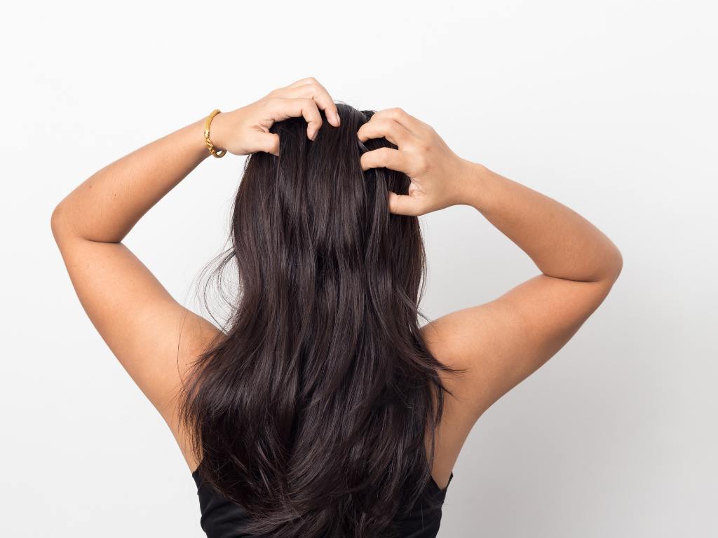 Mulher colocando as mãos no cabelo