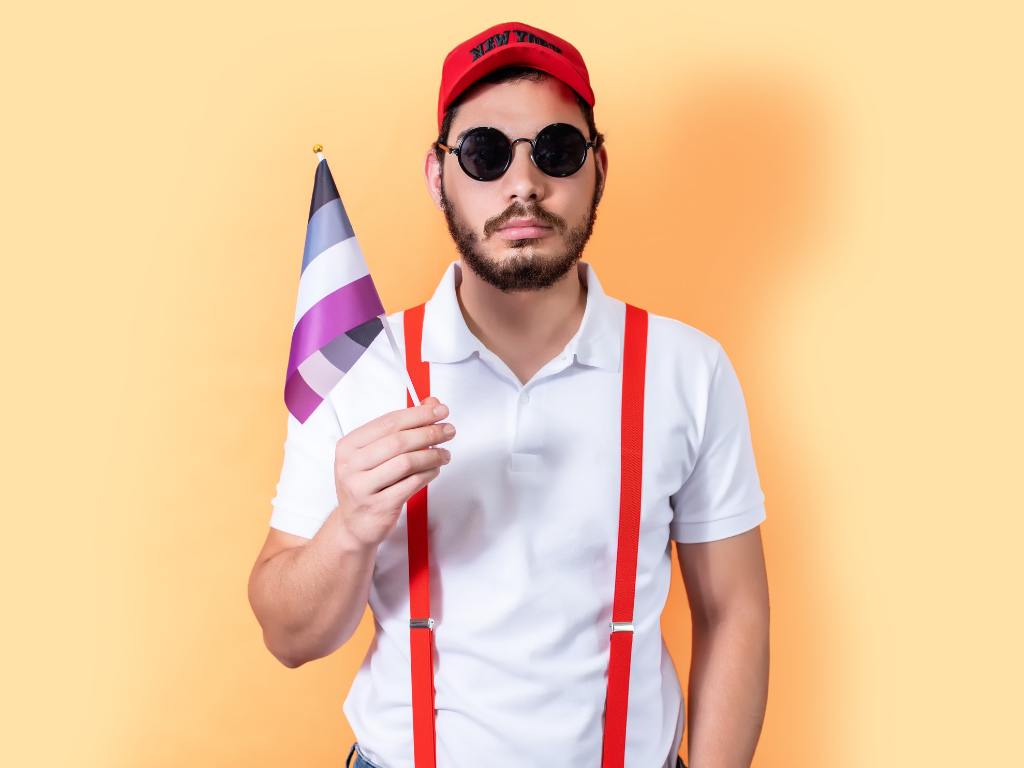 Homem segurando uma bandeira do orgulho assexual