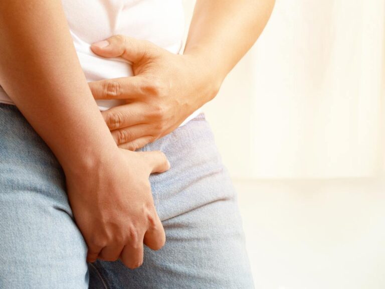 Homem com mãos cobrindo suas partes intimas