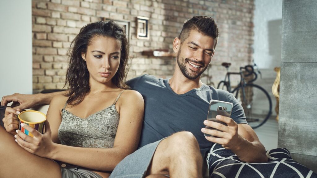 mulher tentando olhar celular de namorado